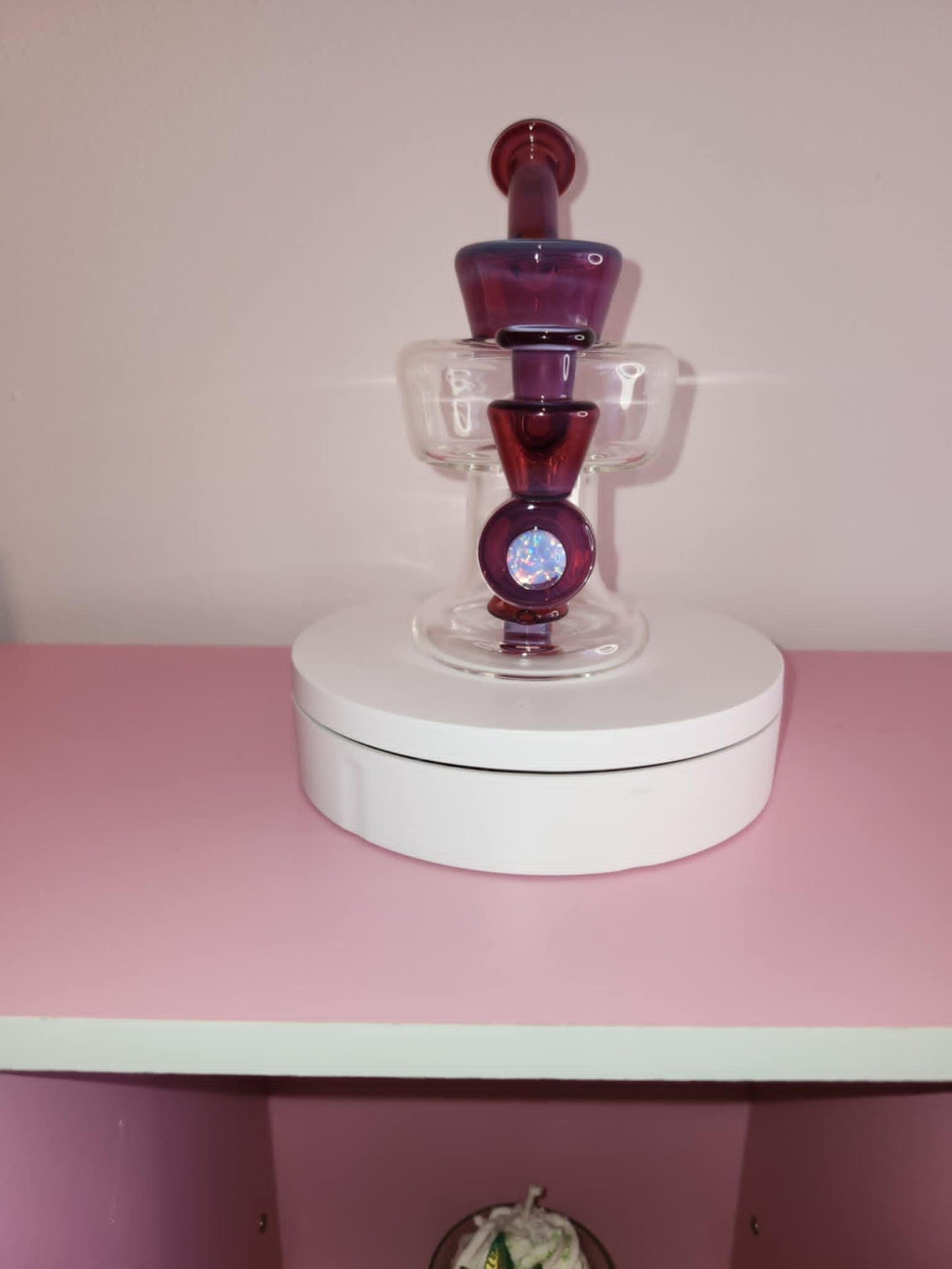 close-up of handblown glass showing rich ruby color depth and smooth sculpted curves of the urn body