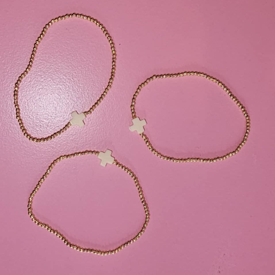 Three Beaded bracelets on a pink backround.