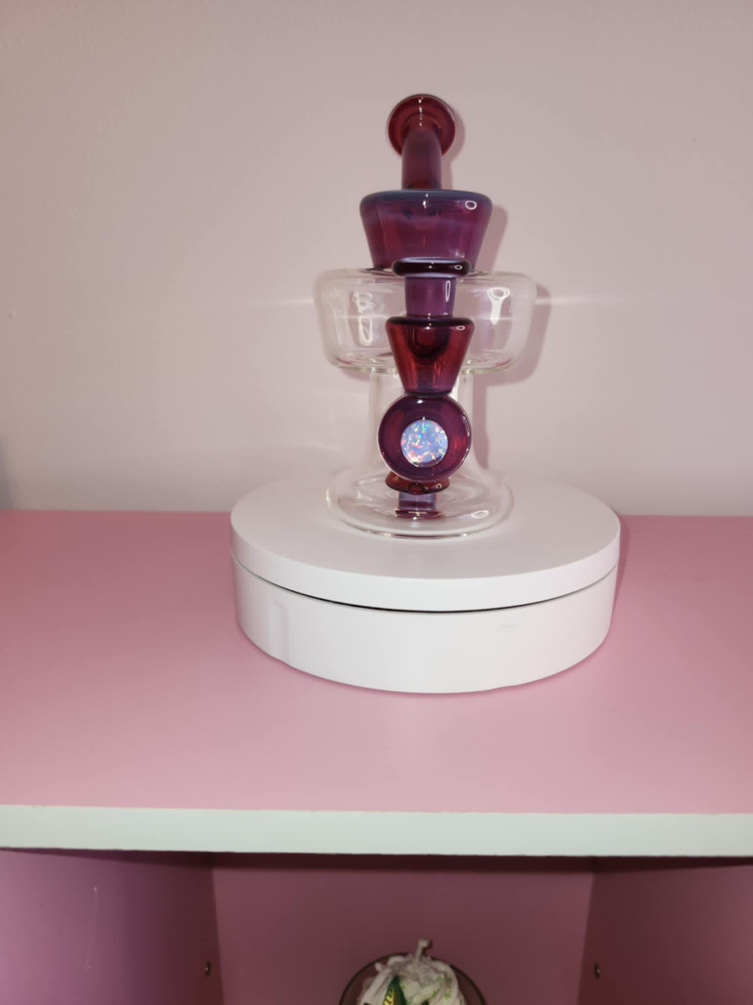 close-up of handblown glass showing rich ruby color depth and smooth sculpted curves of the urn body