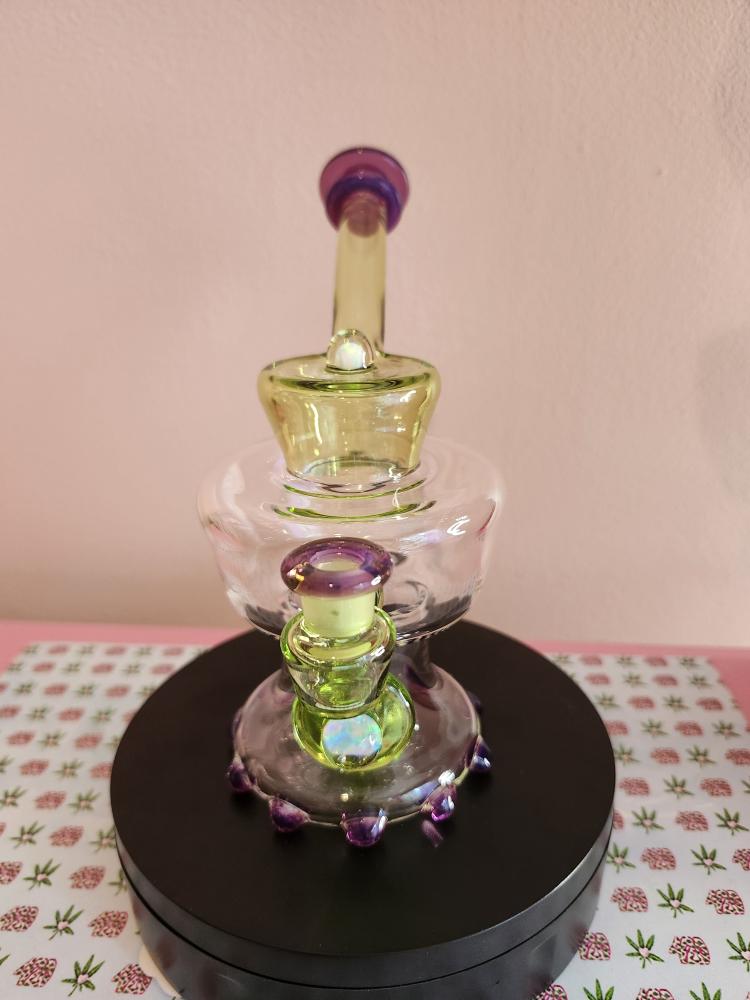 Mac Savage Urn Rig Green Purple glass dab rig shown in full front view highlighting its urn-shaped chamber with green and purple color accents