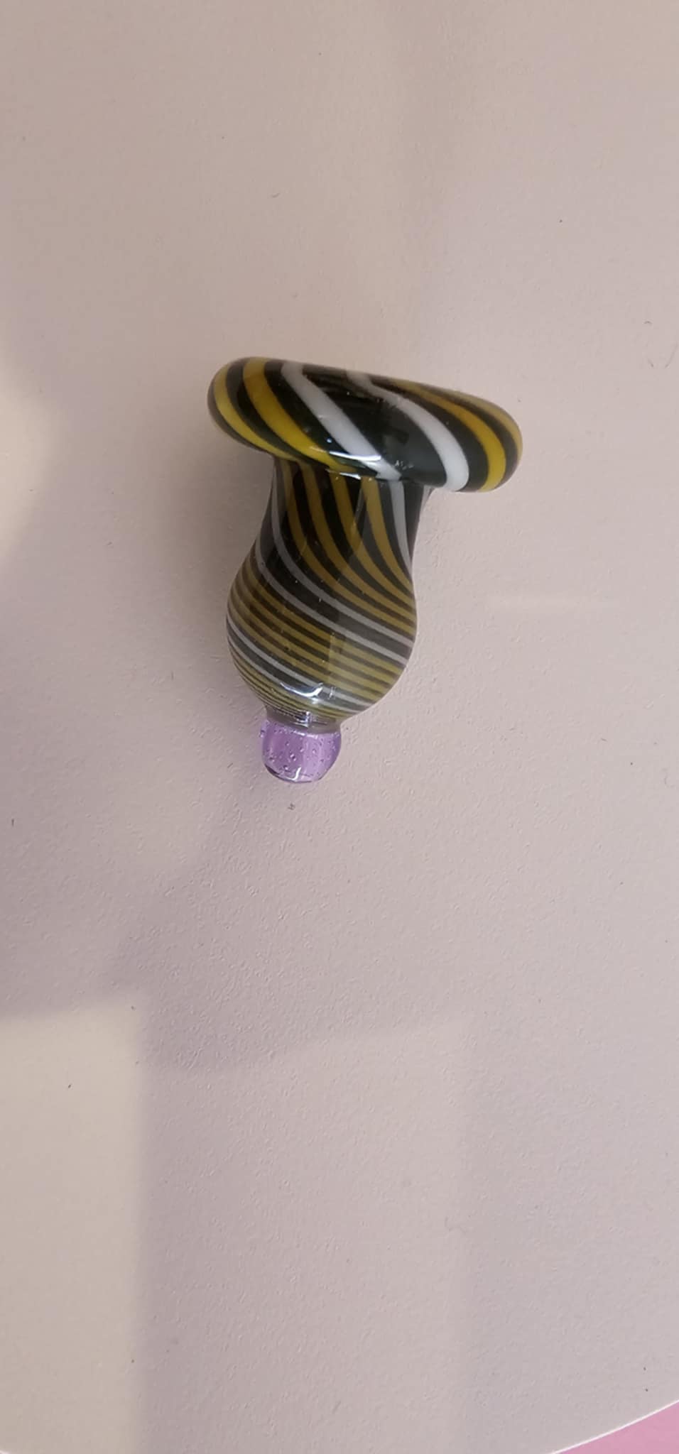 close-up of layered glass swirl pattern showing green yellow and white blending with smooth polished surface texture
