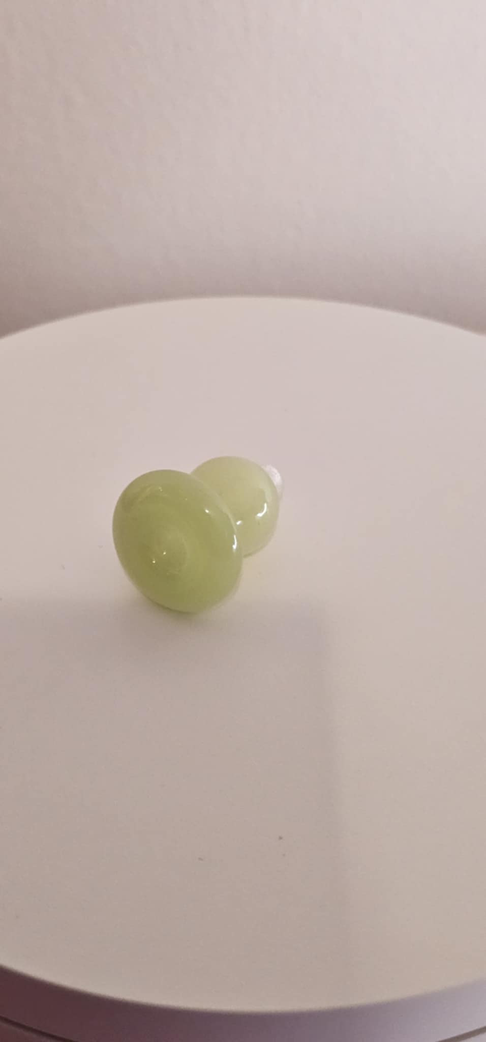 Ghost lime bubble carb cap rotating on quartz banger while vapor flows through dab rig during low-temperature dabbing session