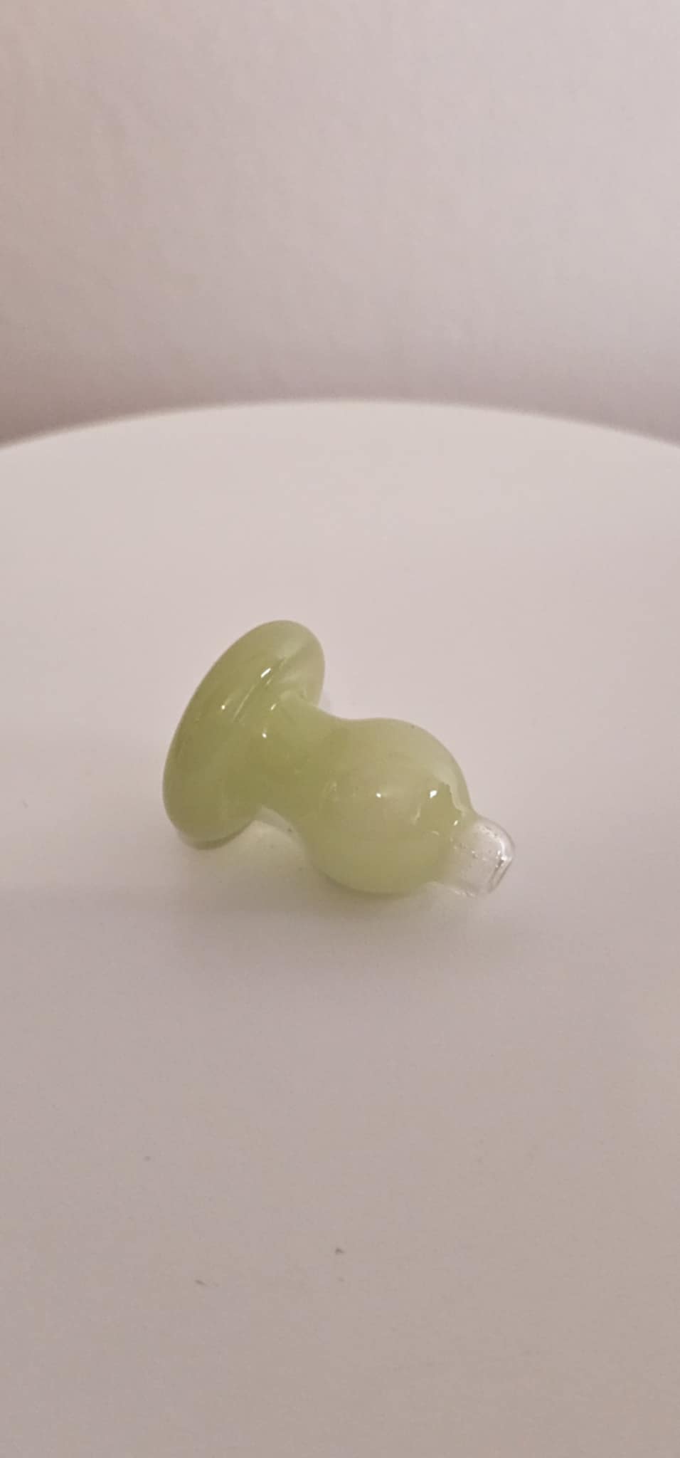 Close-up of glass bubble carb cap highlighting smooth greenish lime glass finish and rounded airflow control opening