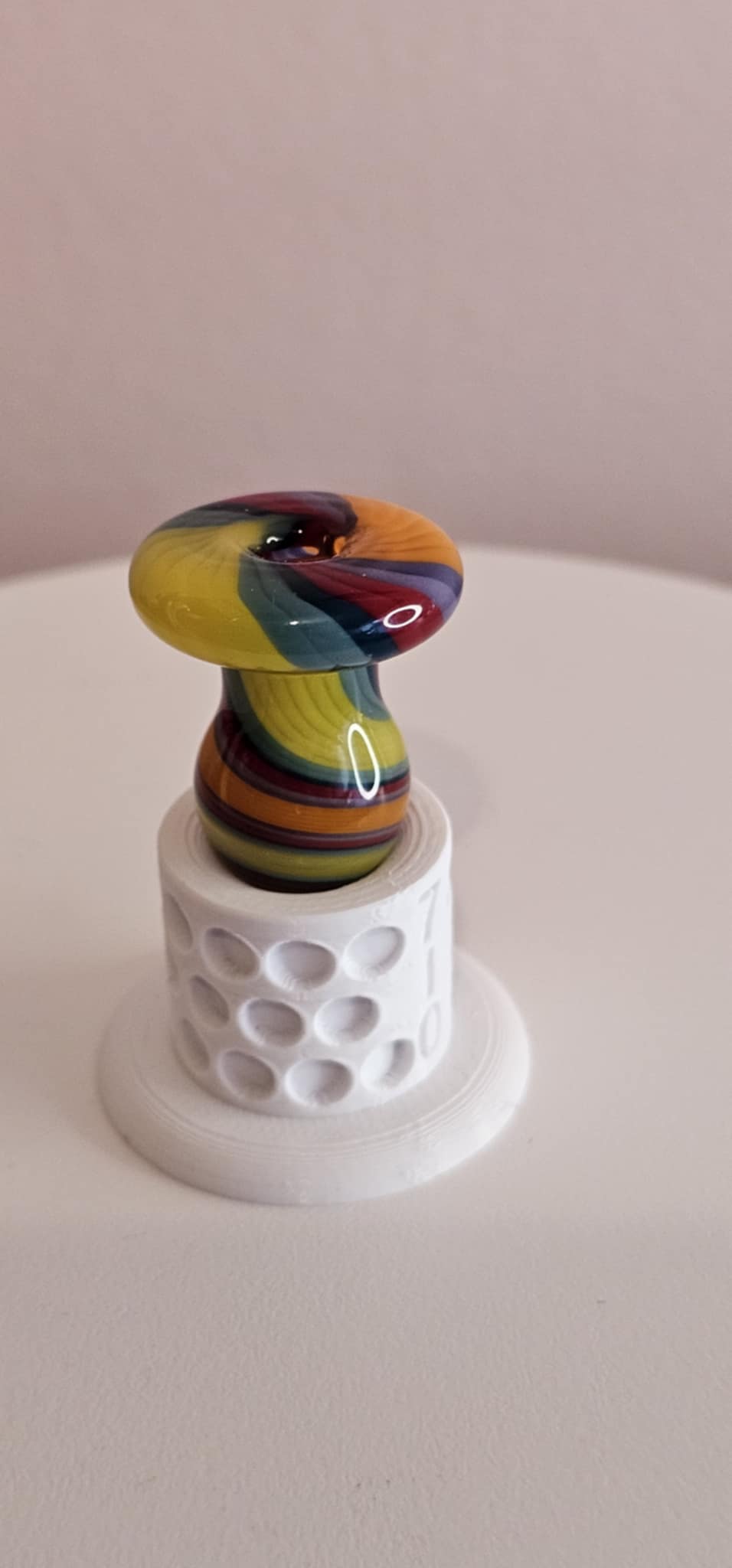 Glass Bubble Cap Orange Black Swirl with red, green, and yellow accents in a rounded bubble shape for dab rig airflow control