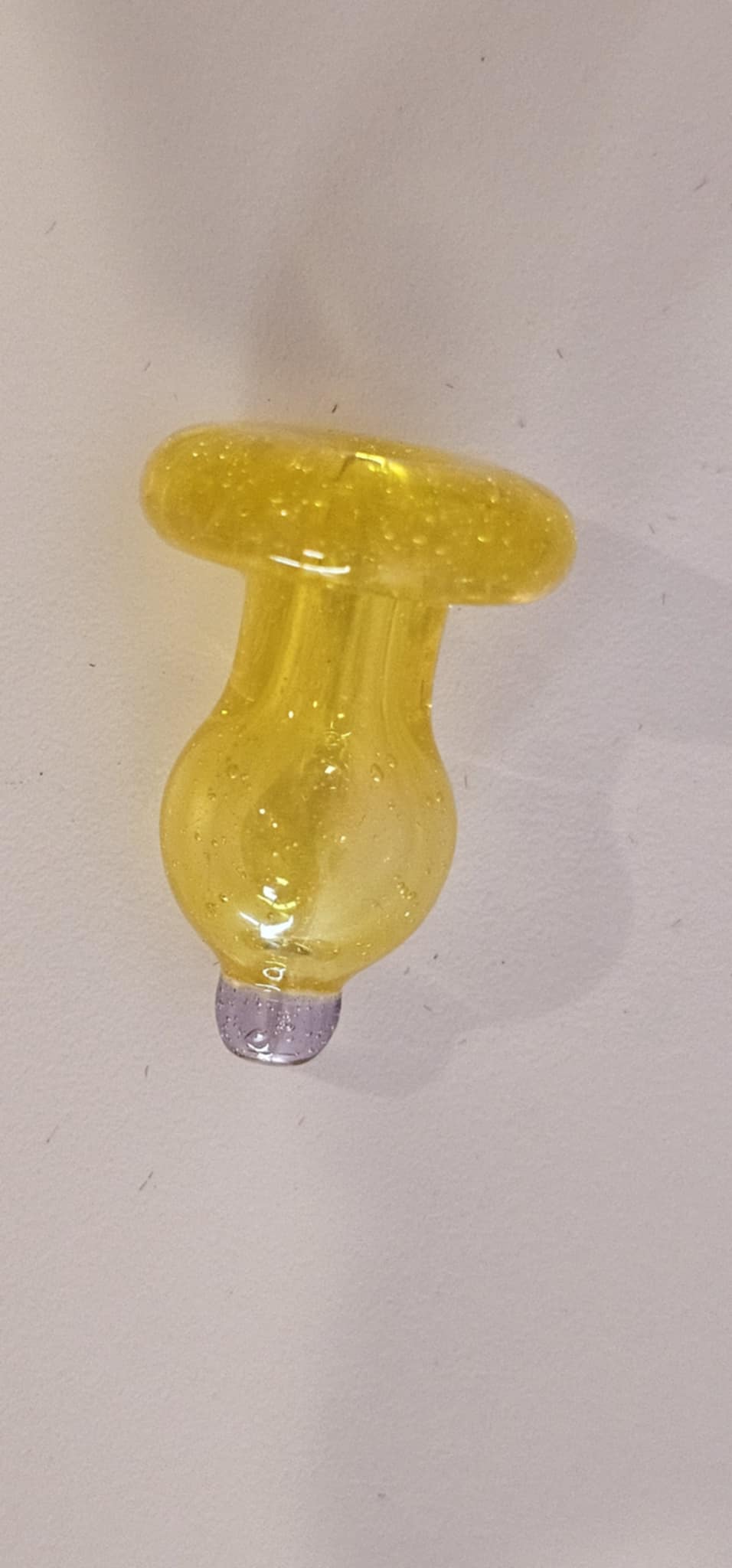 Close-up of PADD Glass yellow bubble cap showing directional airflow design