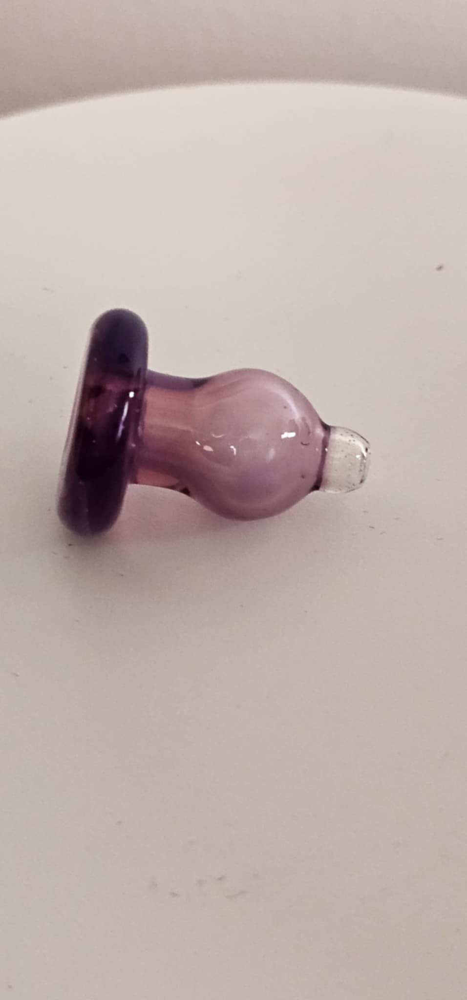 Padd Glass karmaline carb cap with gold ruby opalescent color rotating over flat-top banger

