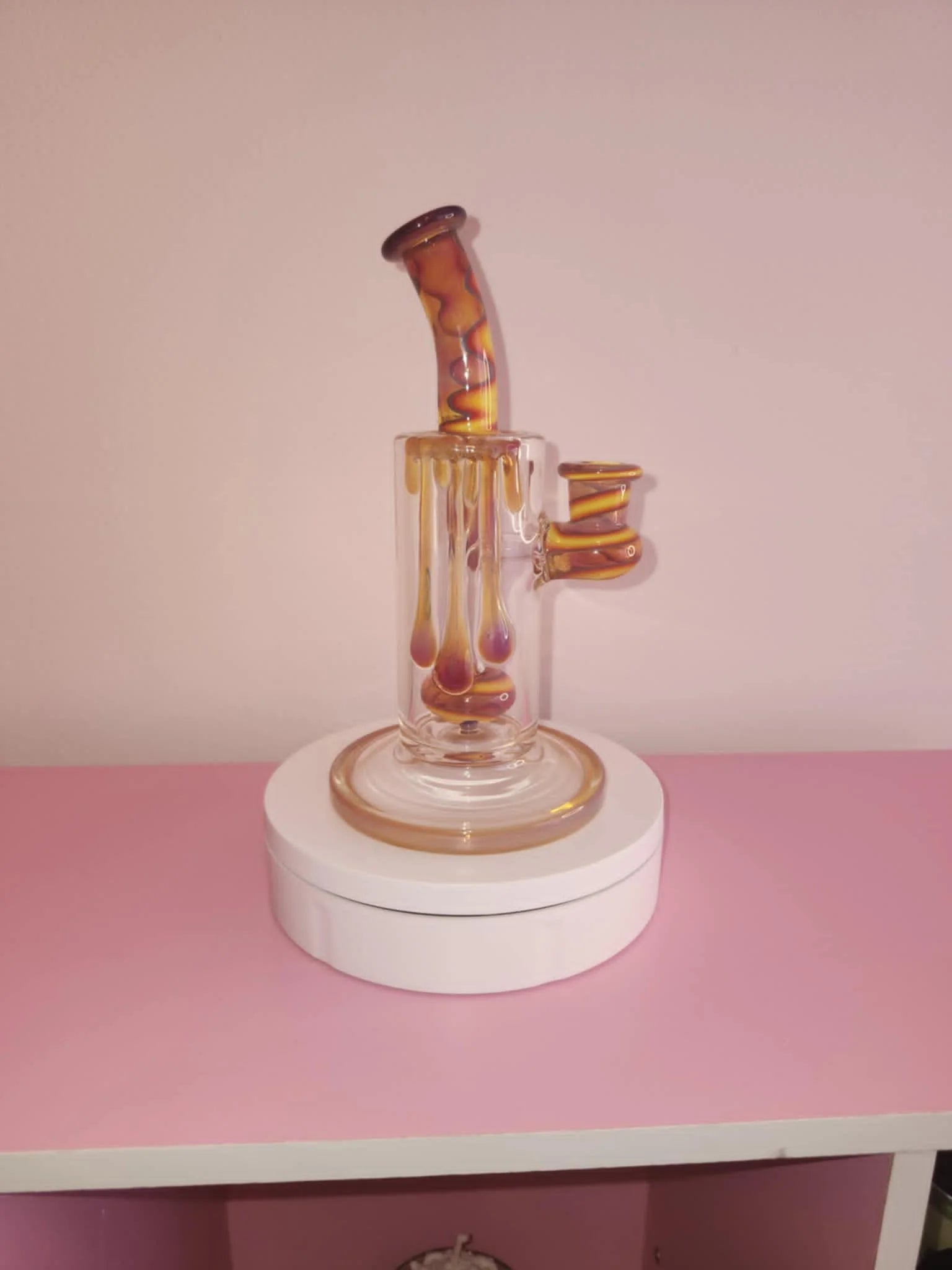Uzzi Drip Bubbler Orange compact glass bubbler with orange drip finish and curved water chamber designed for smooth filtered hits